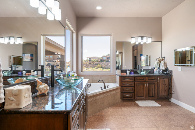 2376 Stone Crest Circle St. George, UT 84790 - Photo 24 of 61 Bathroom featuring two vanities, a bath, and recessed lighting