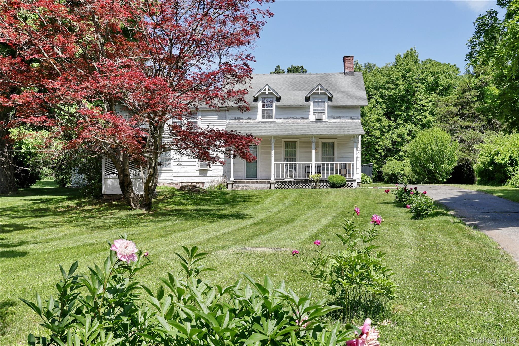 500 Haverstraw Road Suffern, NY 10901 - Photo 30 of 36 a front view of a house with fountain and large trees