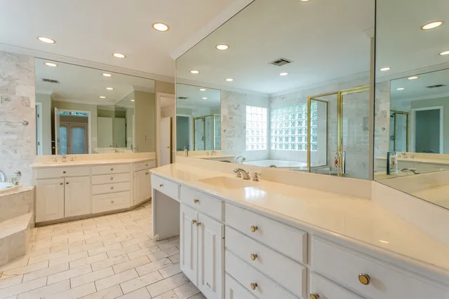 a spacious bathroom with a granite countertop sink mirror and shower