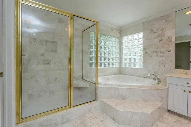 a spacious bathroom with a shower a bathtub and a sink