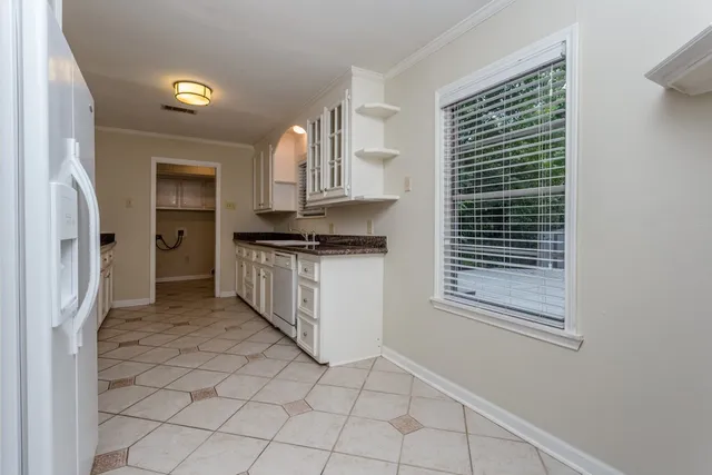 a kitchen with stainless steel appliances a refrigerator and a sink
