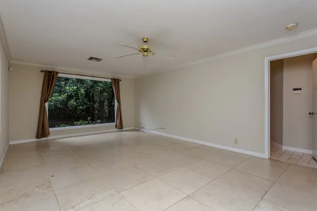 a view of a livingroom with a ceiling fan and window