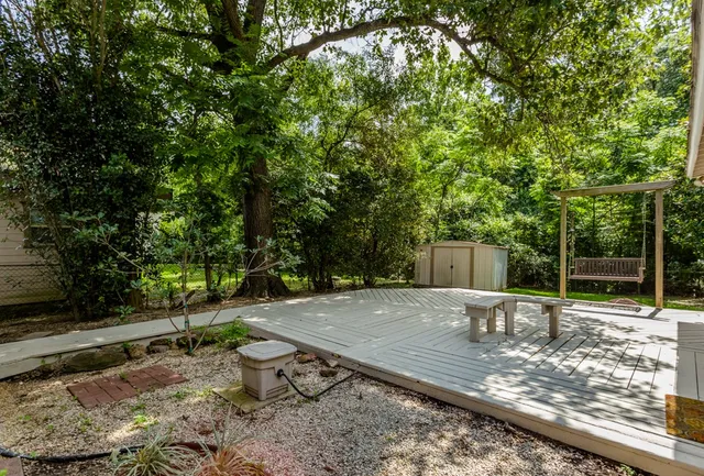 a view of a backyard with wooden fence