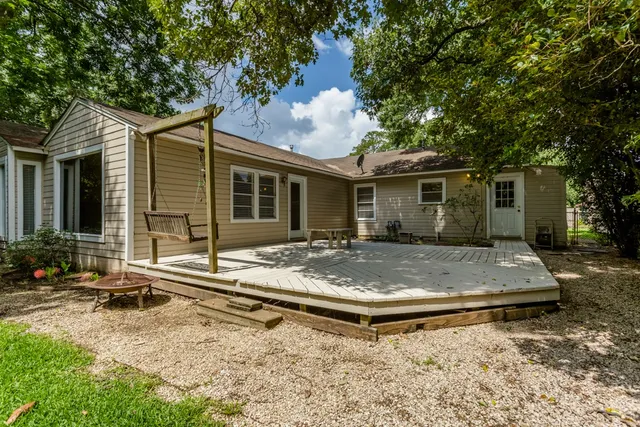 a view of house with backyard and sitting area