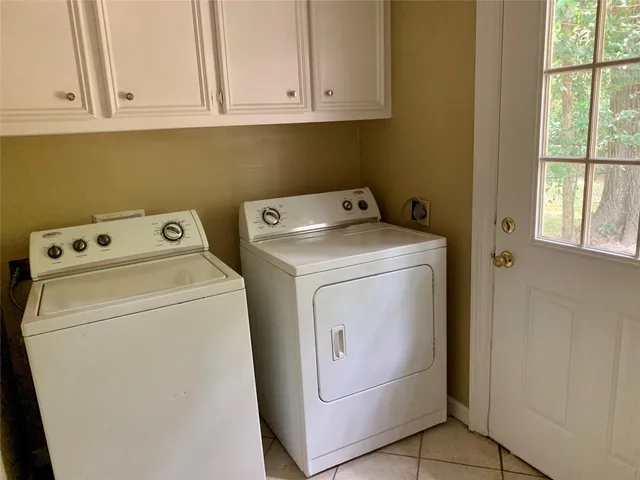 a view of house with backyard and sitting area