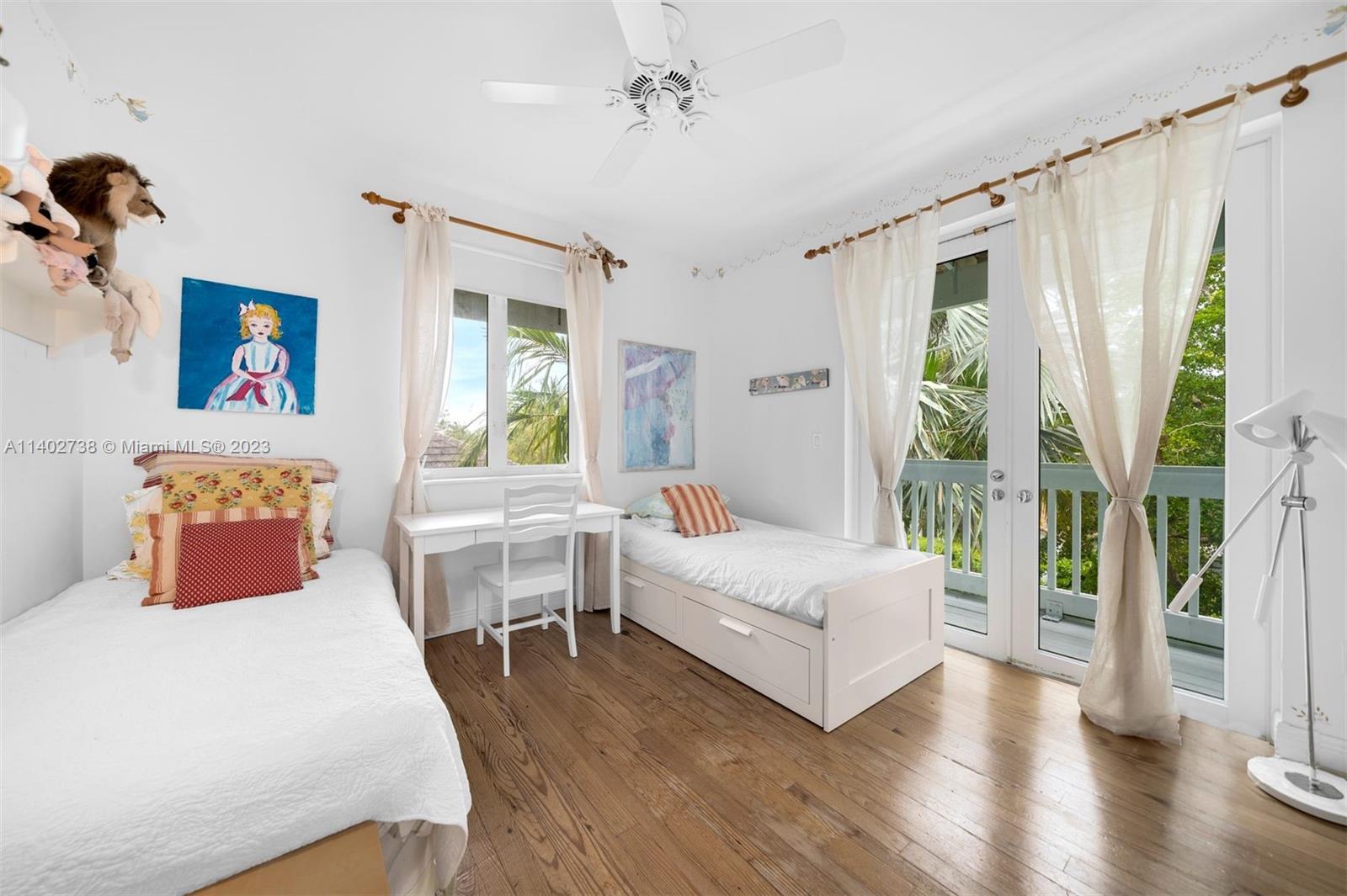 265 Hampton Lane Key Biscayne, FL 33149 - Photo 14 of 23 a bedroom with a bed and a table