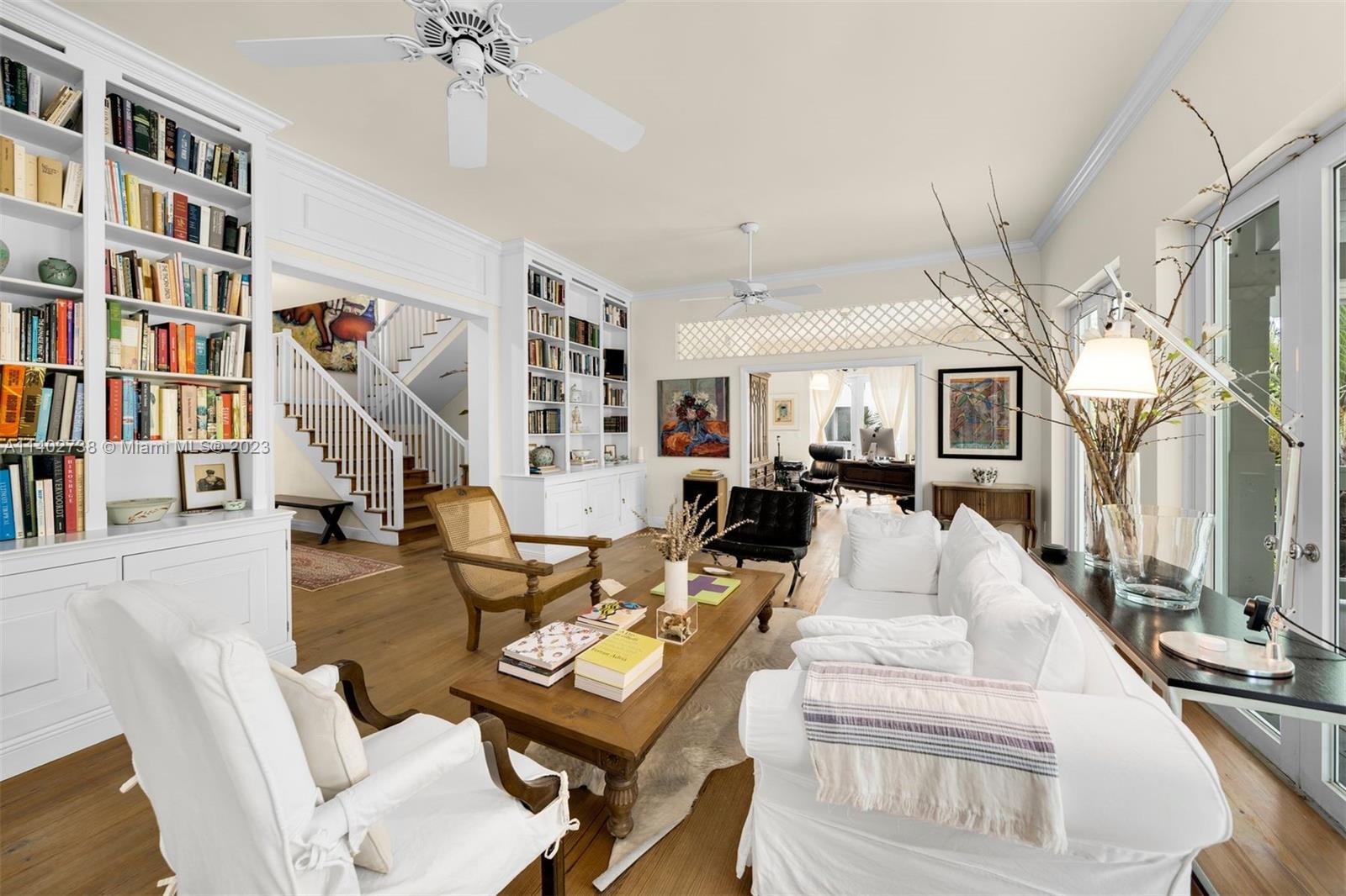 265 Hampton Lane Key Biscayne, FL 33149 - Photo 5 of 23 a living room with furniture a bookshelf and a book shelf