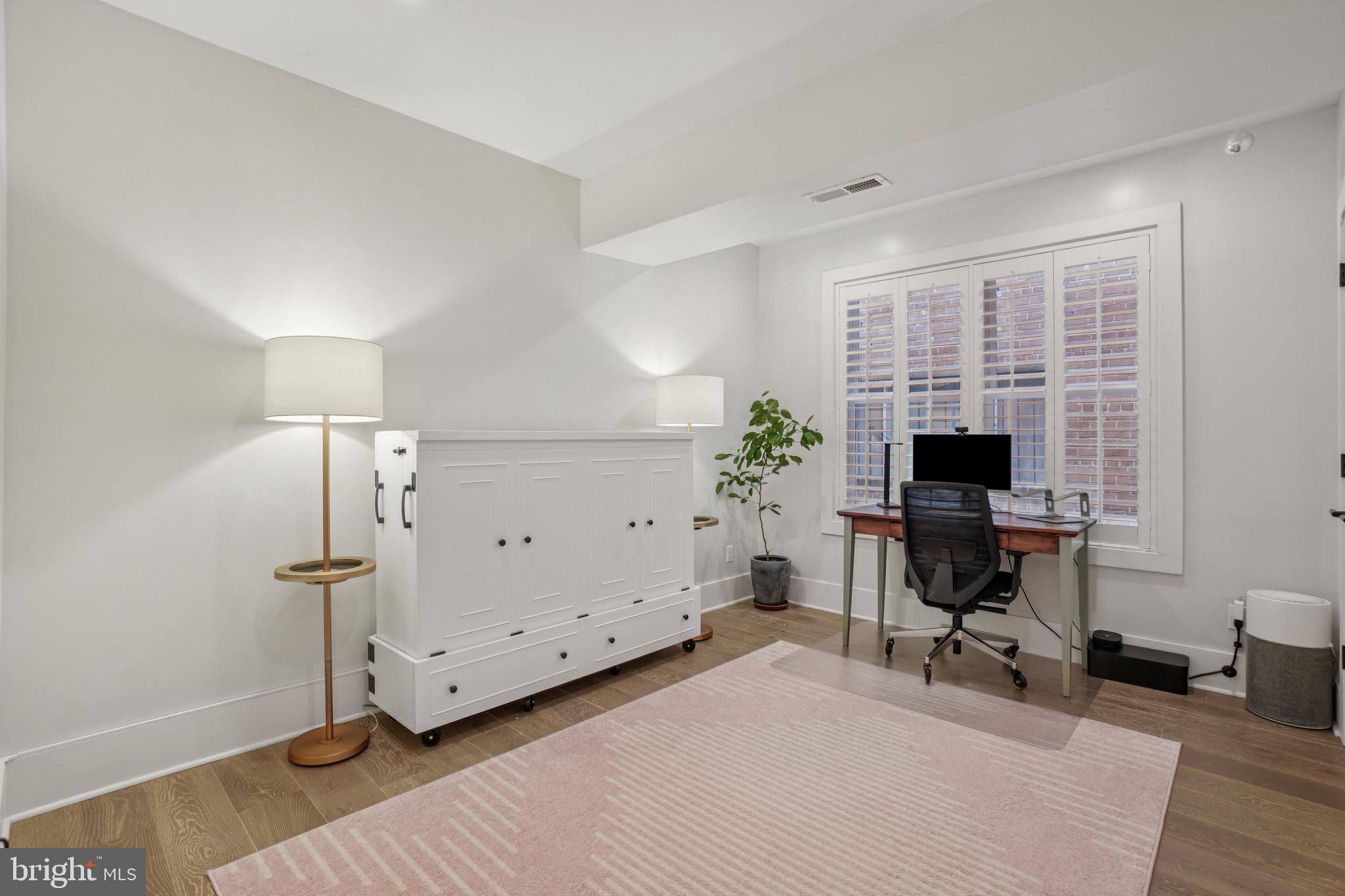 1682 Irving Street Northwest, Unit 2 Washington, DC 20010 - Photo 10 of 25 a view of a workspace with furniture and a window