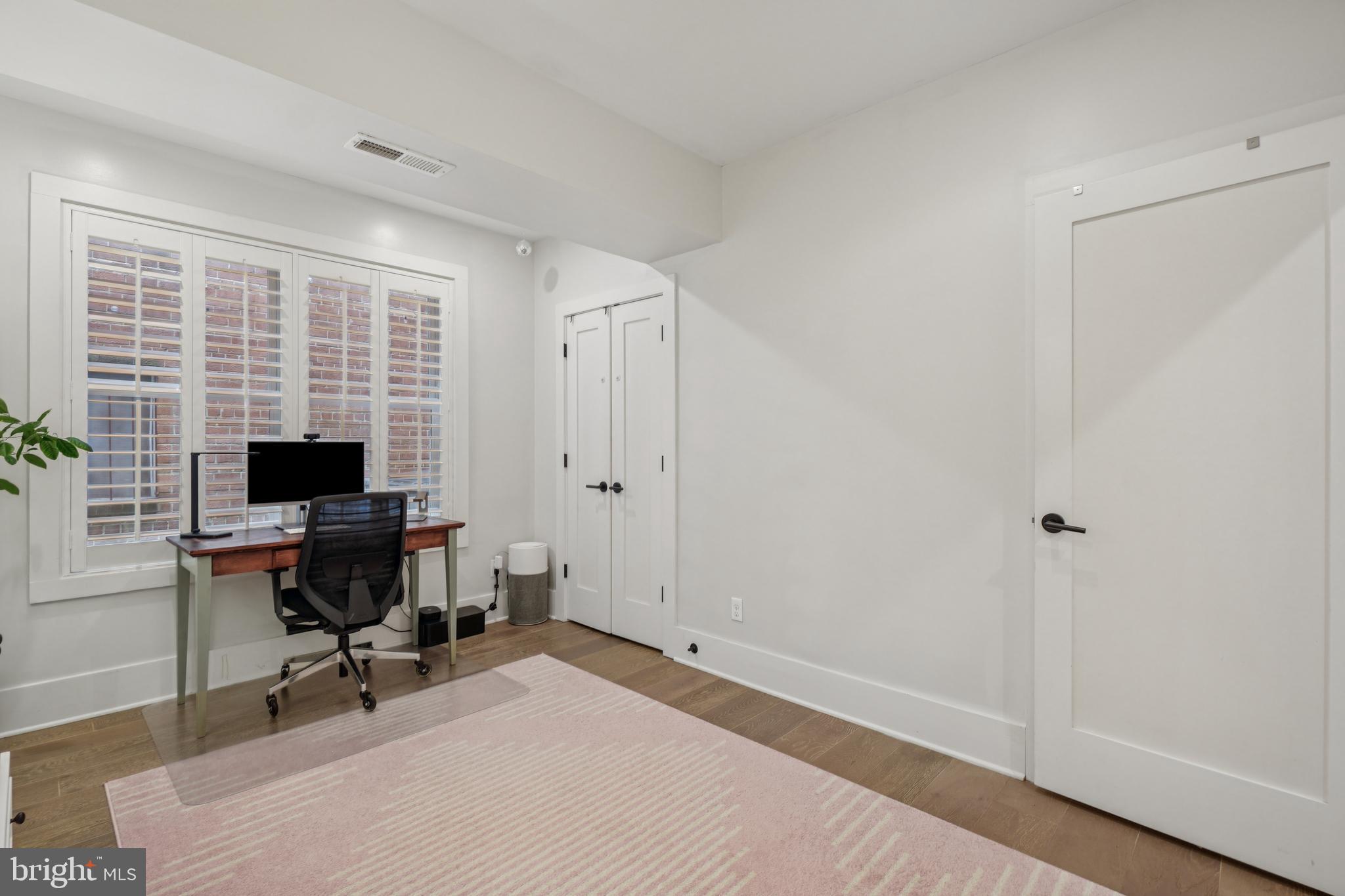 1682 Irving Street Northwest, Unit 2 Washington, DC 20010 - Photo 11 of 25 a view of a workspace with furniture and a window