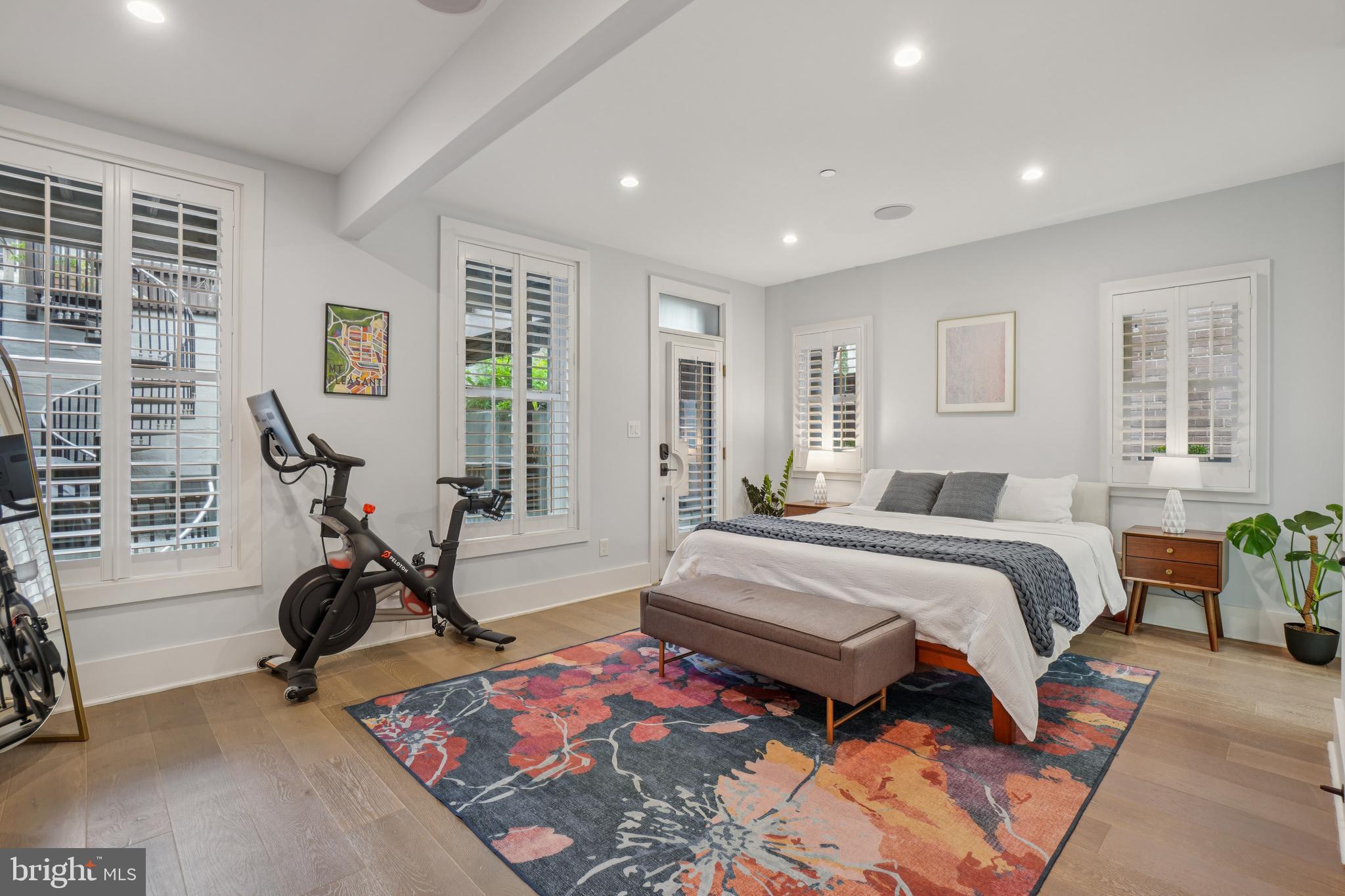 1682 Irving Street Northwest, Unit 2 Washington, DC 20010 - Photo 15 of 25 a bedroom with bed mirror and window