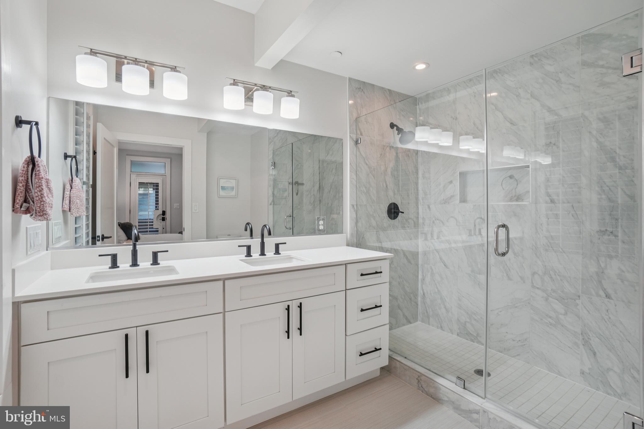 1682 Irving Street Northwest, Unit 2 Washington, DC 20010 - Photo 18 of 25 a bathroom with a double vanity sink mirror and shower