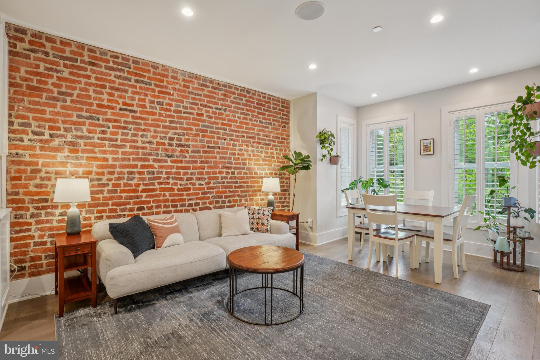 1682 Irving Street Northwest, Unit 2 Washington, DC 20010 - Photo 2 of 25 a living room with furniture a rug and a lamp