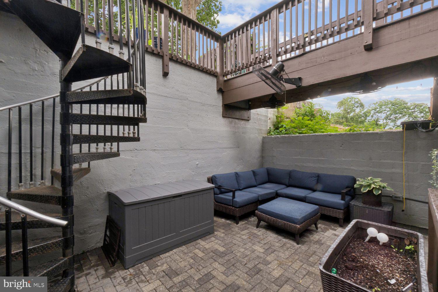 1682 Irving Street Northwest, Unit 2 Washington, DC 20010 - Photo 20 of 25 a view of a patio with couches table and chairs with wooden floor
