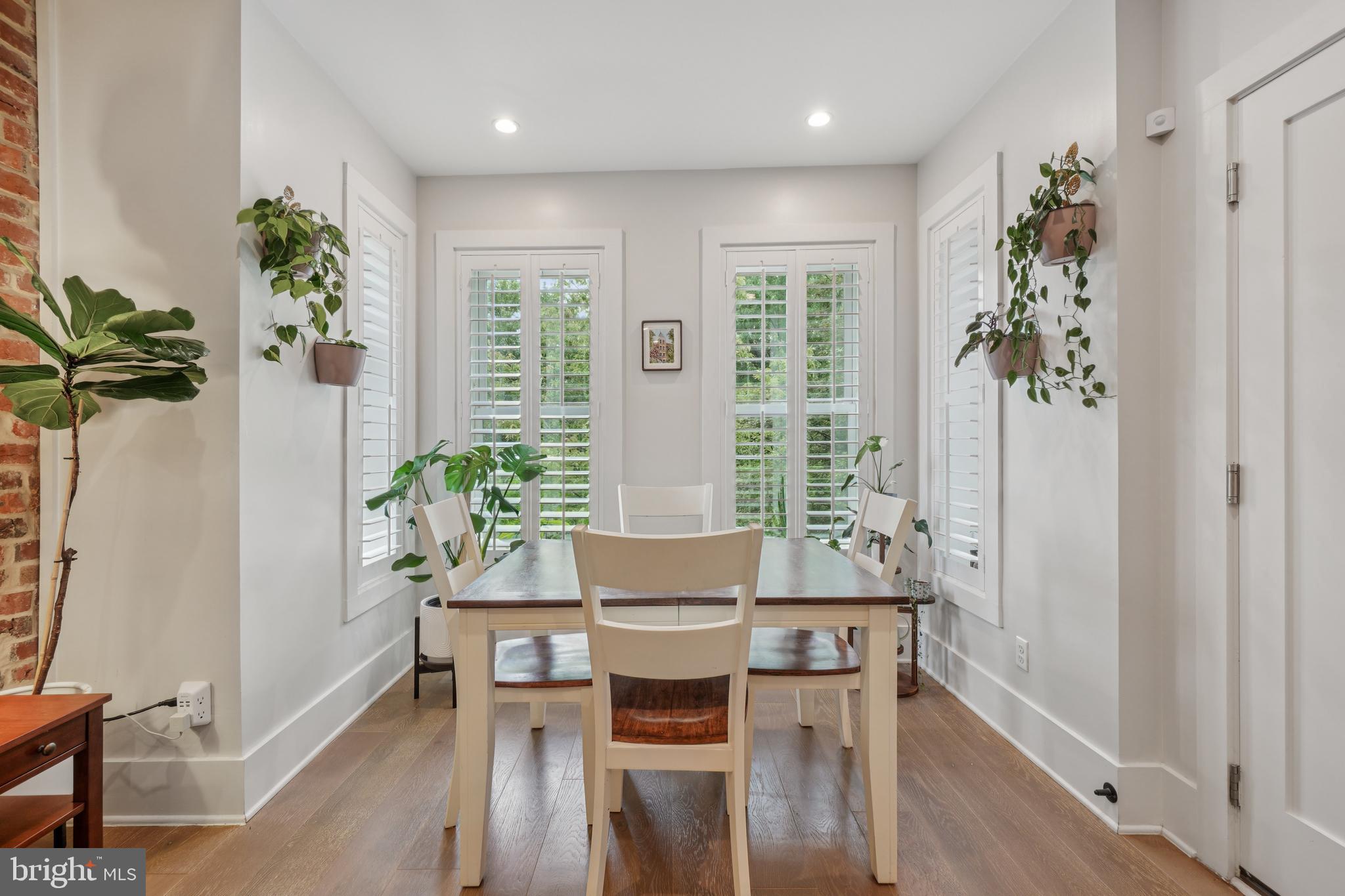 1682 Irving Street Northwest, Unit 2 Washington, DC 20010 - Photo 3 of 25 a view of a dining room with furniture window and wooden floor