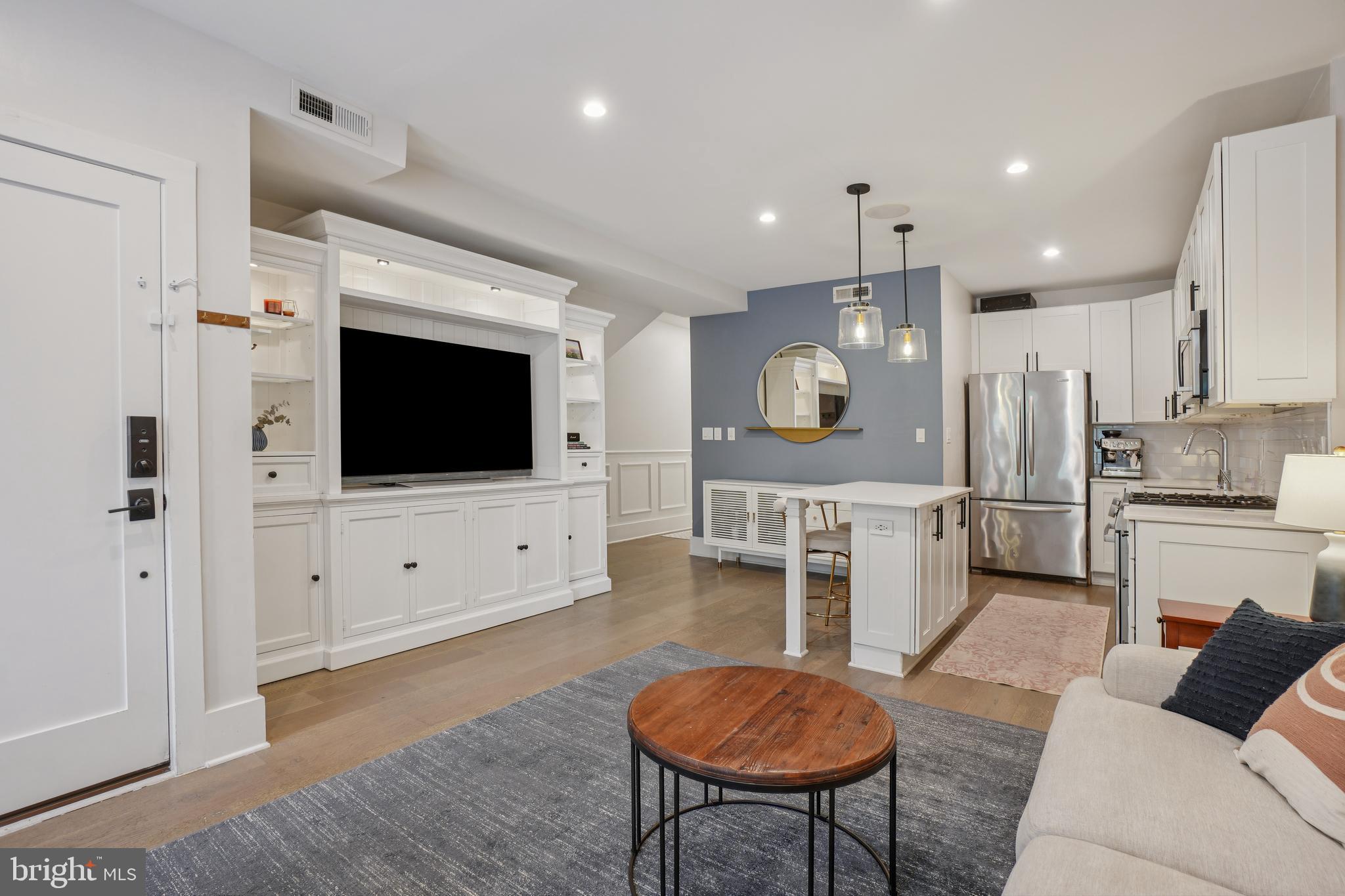 1682 Irving Street Northwest, Unit 2 Washington, DC 20010 - Photo 4 of 25 a living room with furniture and a flat screen tv
