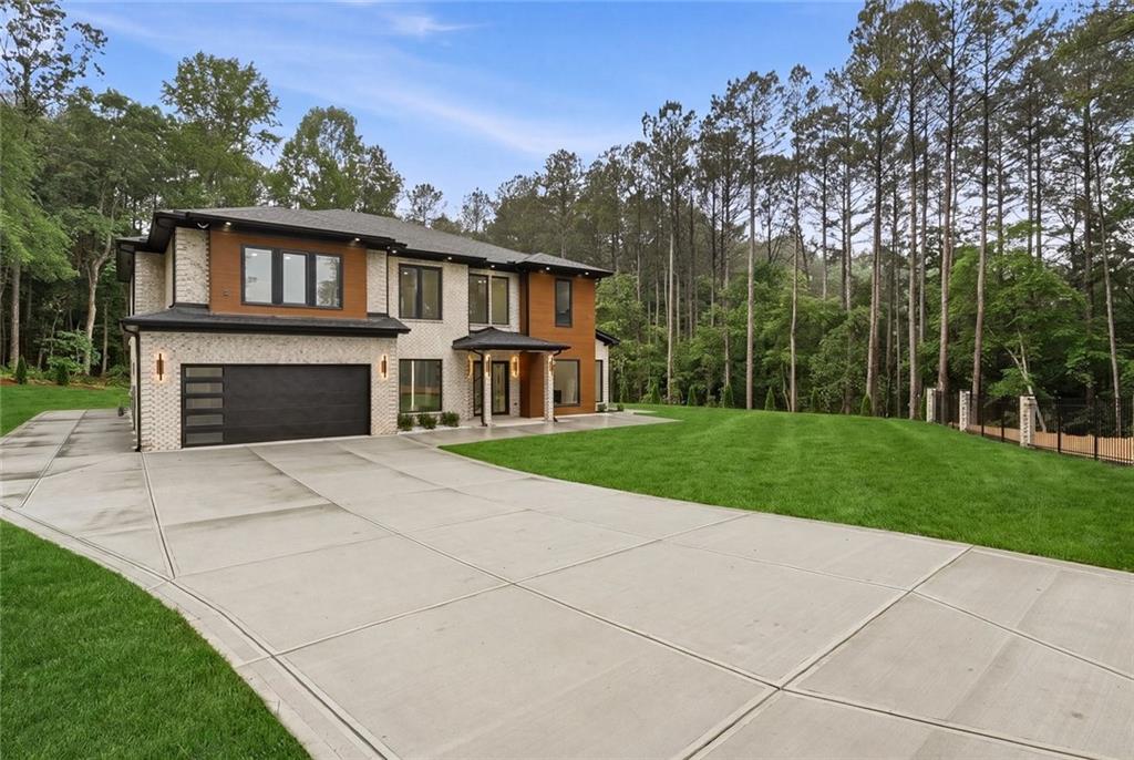 1563 Whitley Road Dacula, GA 30019 - Photo 2 of 44 a front view of a house with yard and green space
