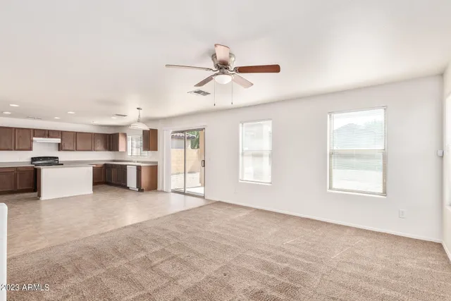 a view of empty room with ceiling fan