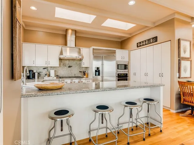 a kitchen with stainless steel appliances granite countertop a sink and cabinets