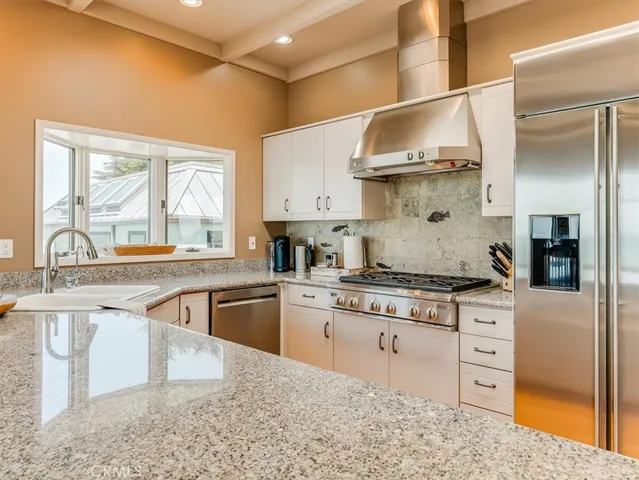 a kitchen with stainless steel appliances granite countertop a stove and a sink