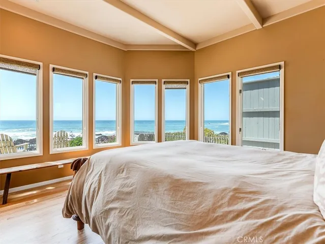 a bedroom with a bed and a large window