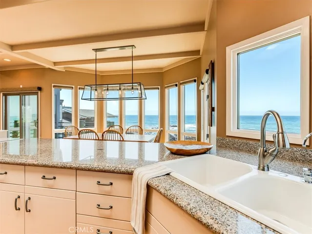 a kitchen with granite countertop a sink and a window