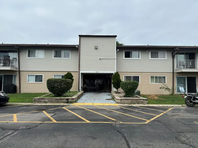 a view of building with couches in front of house