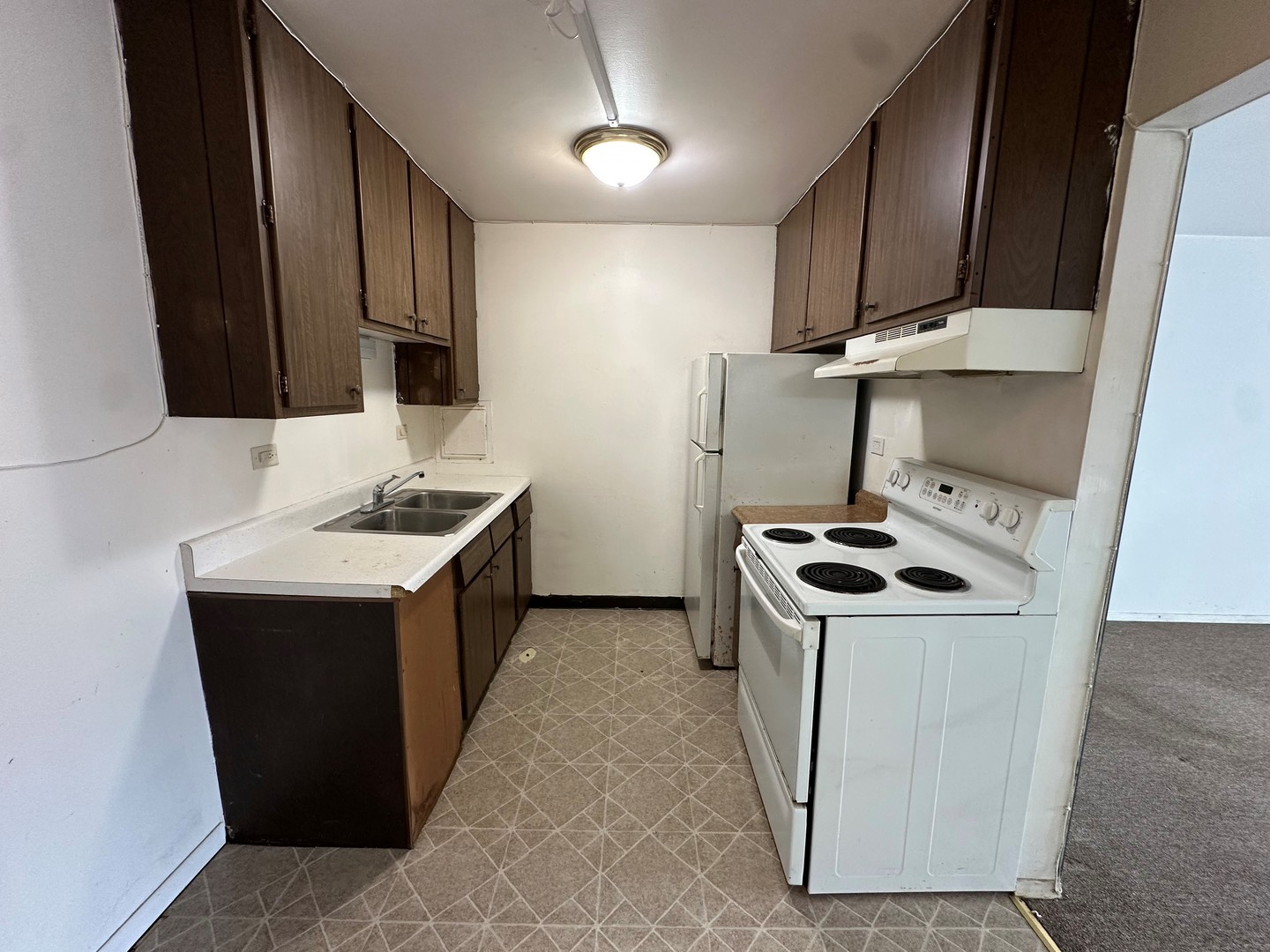 850 East Old Willow Road, Unit 108 Prospect Heights, IL 60070 - Photo 7 of 9 a kitchen with a stove sink and a refrigerator