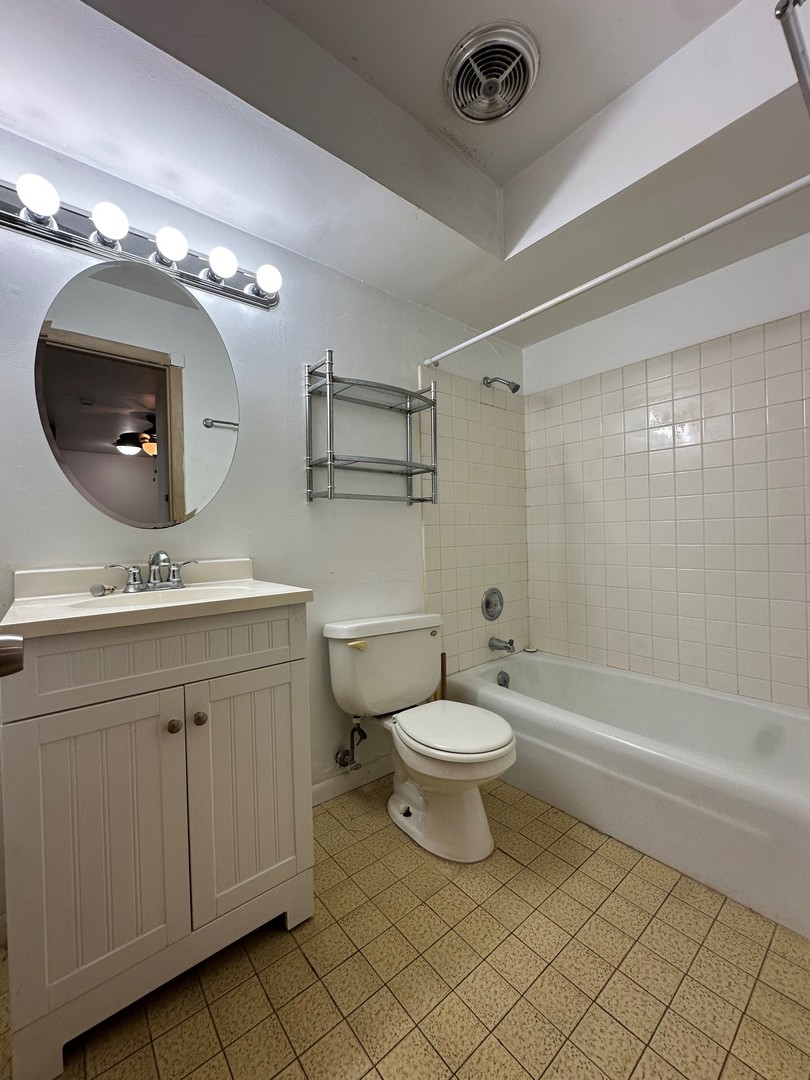 850 East Old Willow Road, Unit 108 Prospect Heights, IL 60070 - Photo 9 of 9 a bathroom with a double vanity sink a toilet a mirror and shower
