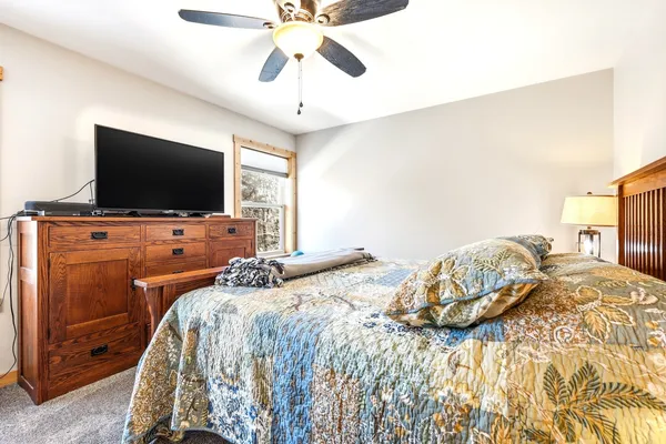 a bedroom with a bed and a flat screen tv