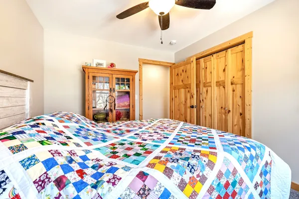 a bedroom with a bed and a chandelier