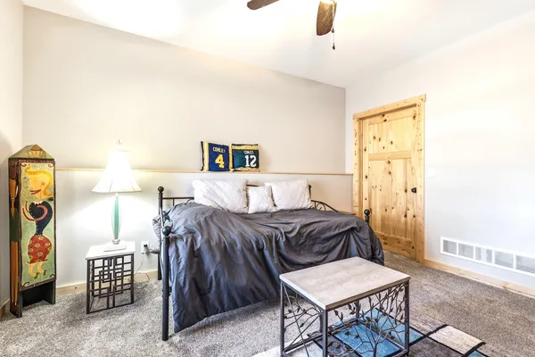 a bedroom with a bed and a chandelier