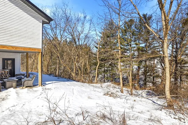 a view of a backyard with snow on the road
