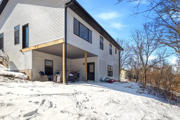 a view of a house with snow in front of house