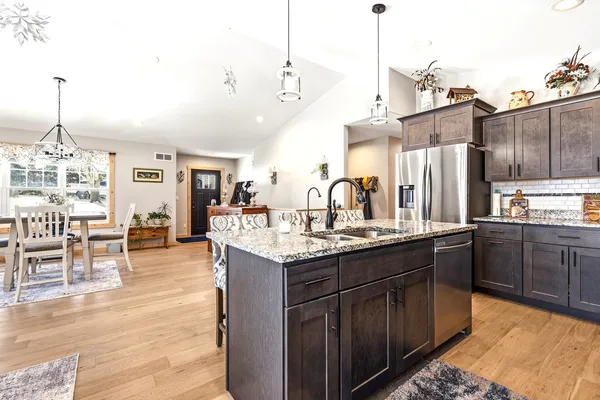 a kitchen with center island appliances and wooden cabinets