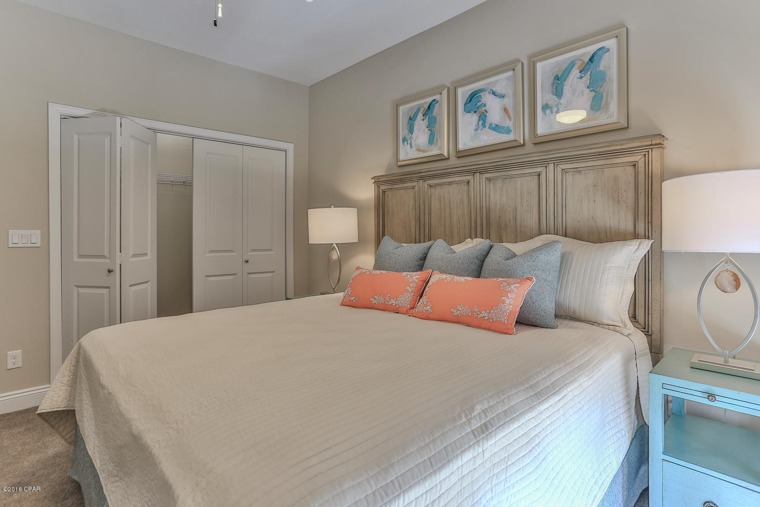 22958 Ann Miller Road Panama City Beach, FL 32413 - Photo 14 of 29 a bedroom with a large bed and a chandelier