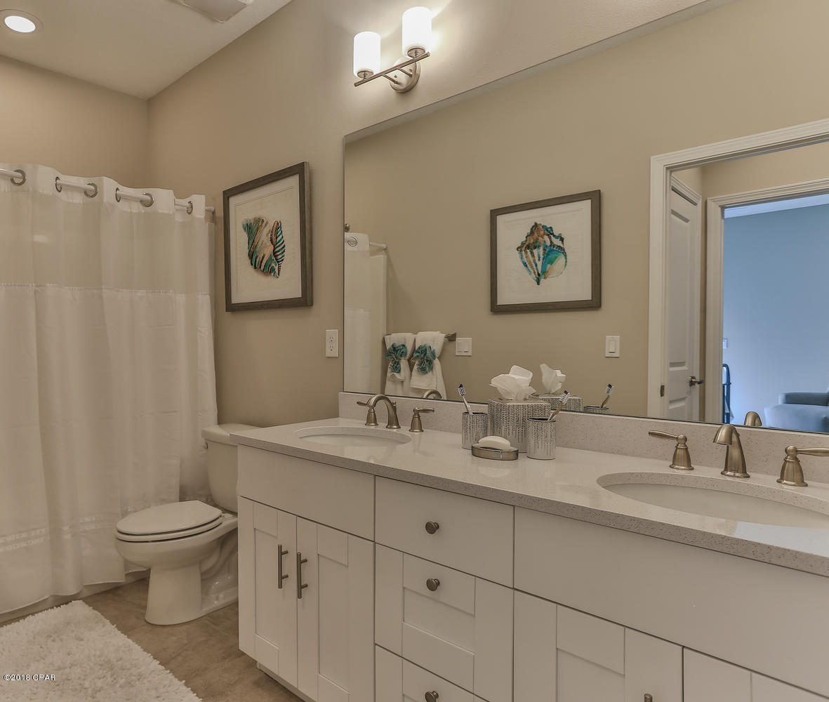 22958 Ann Miller Road Panama City Beach, FL 32413 - Photo 16 of 29 a bathroom with double sink and a mirror