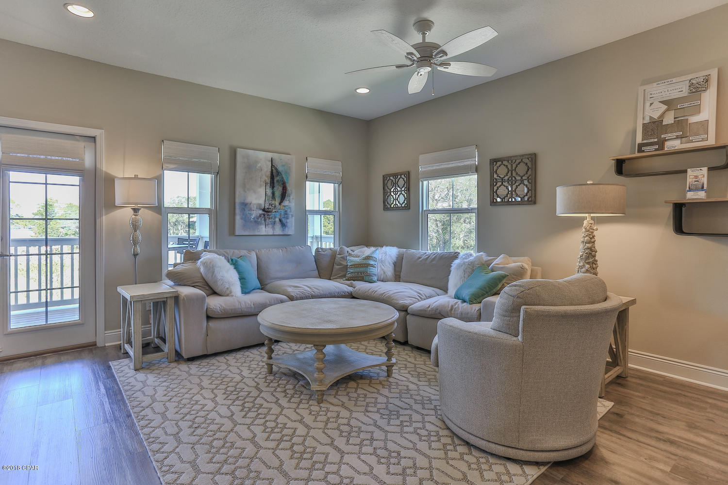 22958 Ann Miller Road Panama City Beach, FL 32413 - Photo 17 of 29 a living room with furniture and a wooden floor