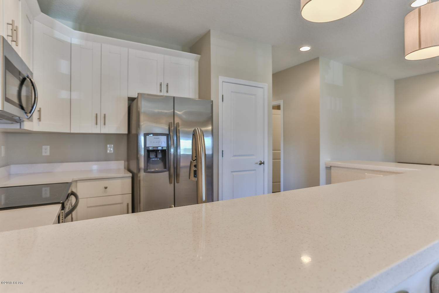22958 Ann Miller Road Panama City Beach, FL 32413 - Photo 19 of 29 a kitchen with stainless steel appliances a refrigerator and cabinets