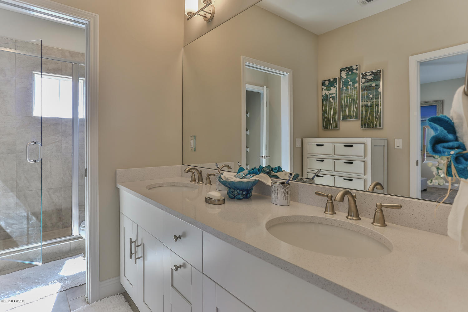 22958 Ann Miller Road Panama City Beach, FL 32413 - Photo 22 of 29 a bathroom with double vanity sinks and a mirror