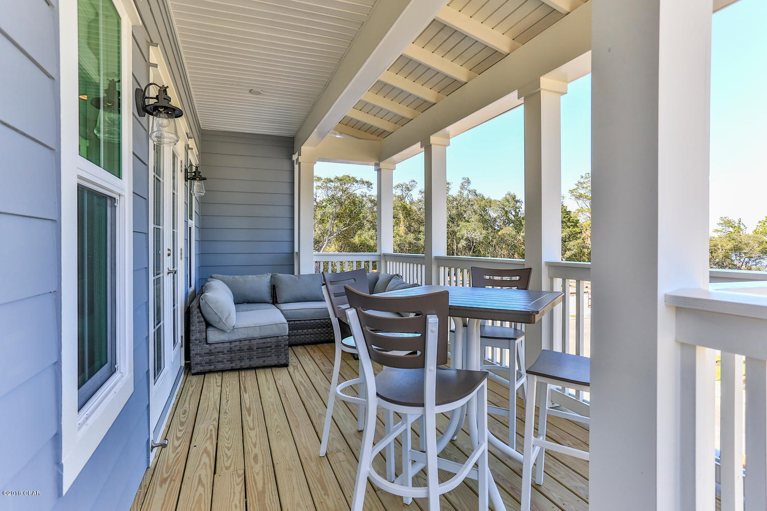 22958 Ann Miller Road Panama City Beach, FL 32413 - Photo 24 of 29 a dining room with furniture and a floor to ceiling window