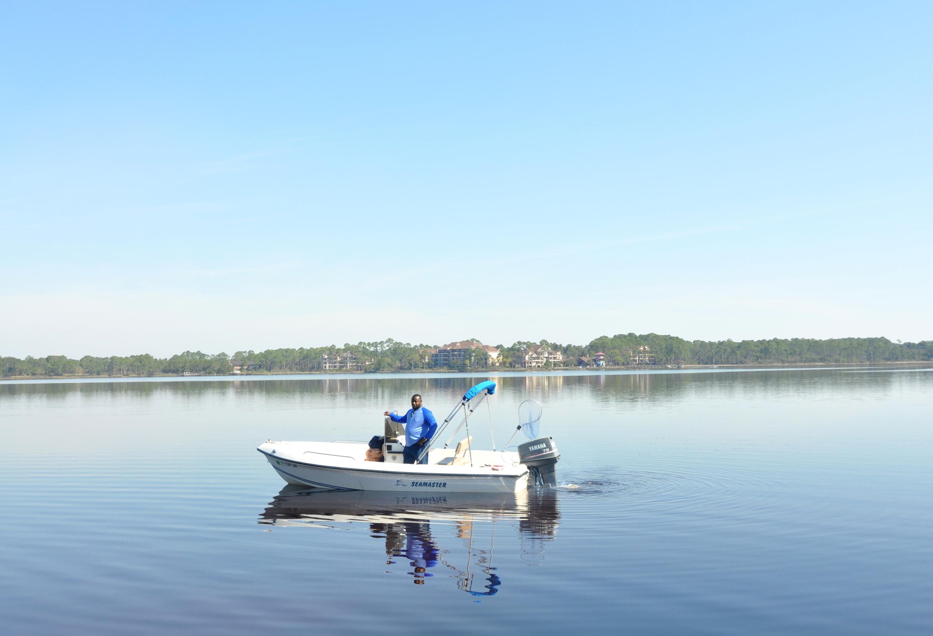 22958 Ann Miller Road Panama City Beach, FL 32413 - Photo 29 of 29 a view of a lake with table and chairs