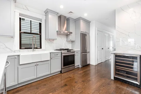 a kitchen with stainless steel appliances a stove top oven and cabinets