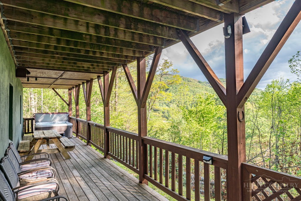 197 Woodby Ridge Road Vilas, NC 28692 - Photo 36 of 45 a view of a porch with wooden floor in stairs