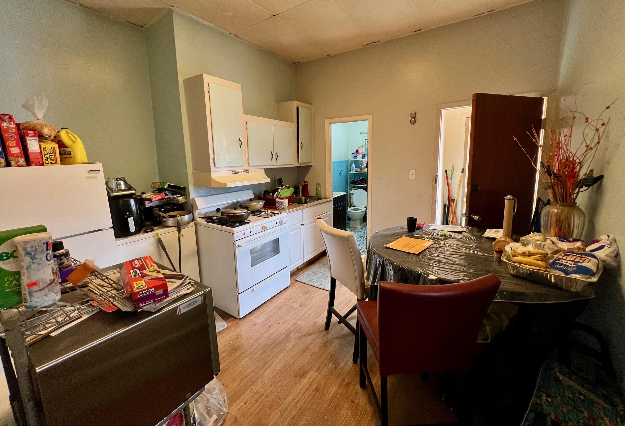 60-85 55th Street Queens, NY 11378 - Photo 3 of 8 a kitchen with stainless steel appliances kitchen island granite countertop a stove and a sink