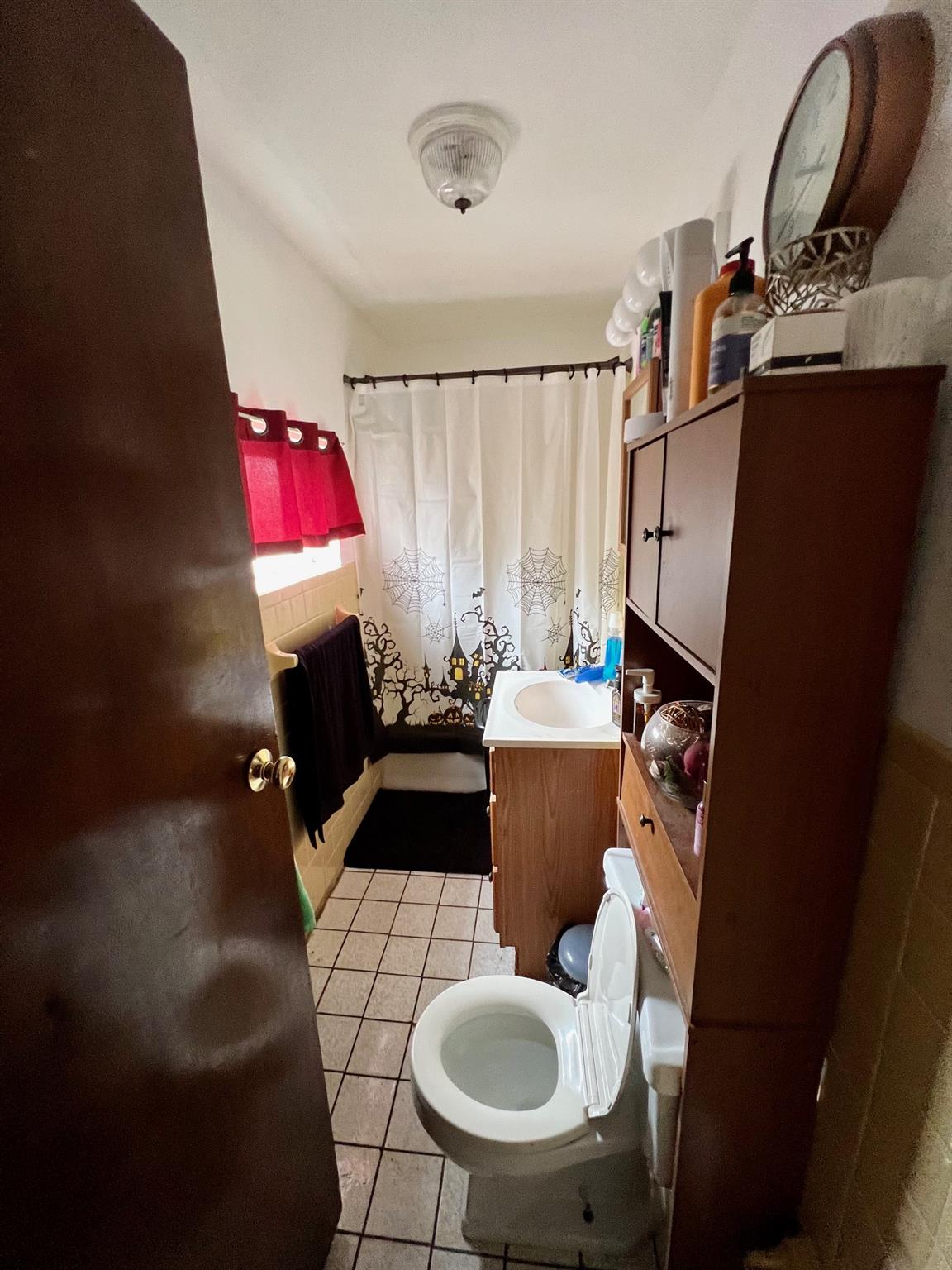 60-85 55th Street Queens, NY 11378 - Photo 4 of 8 a living room with furniture a rug and a fireplace