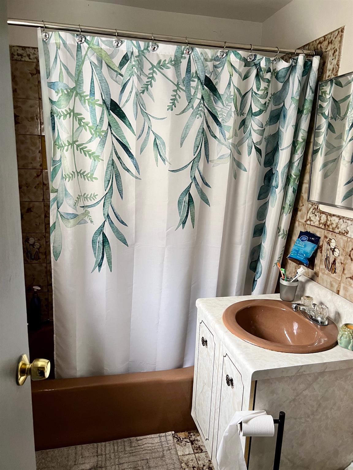 60-85 55th Street Queens, NY 11378 - Photo 7 of 8 a bathroom with a sink and mirror