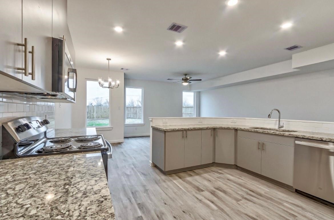 13313 Tetris Drive, Unit B Houston, TX 77048 - Photo 5 of 19 a kitchen with sink stove and refrigerator