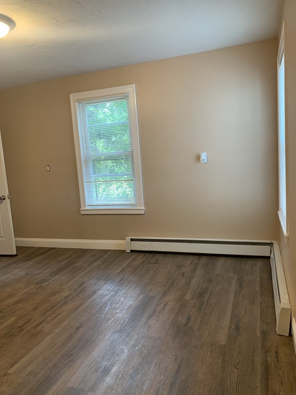 75 Pine Street Springfield, MA 01105 - Photo 23 of 40 a view of an empty room with wooden floor and a window