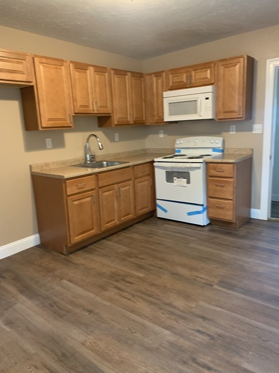 75 Pine Street Springfield, MA 01105 - Photo 27 of 40 a kitchen with stainless steel appliances granite countertop a sink stove and microwave