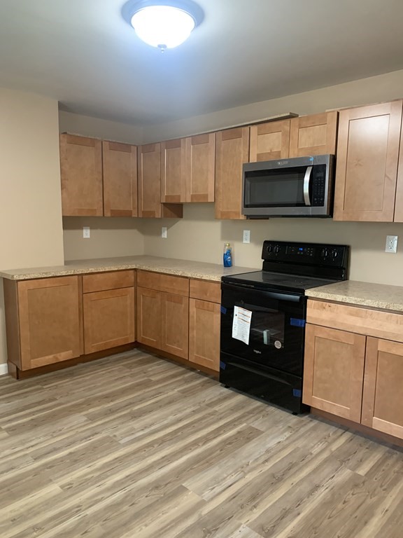 75 Pine Street Springfield, MA 01105 - Photo 32 of 40 a kitchen with stainless steel appliances granite countertop a stove a sink and a refrigerator